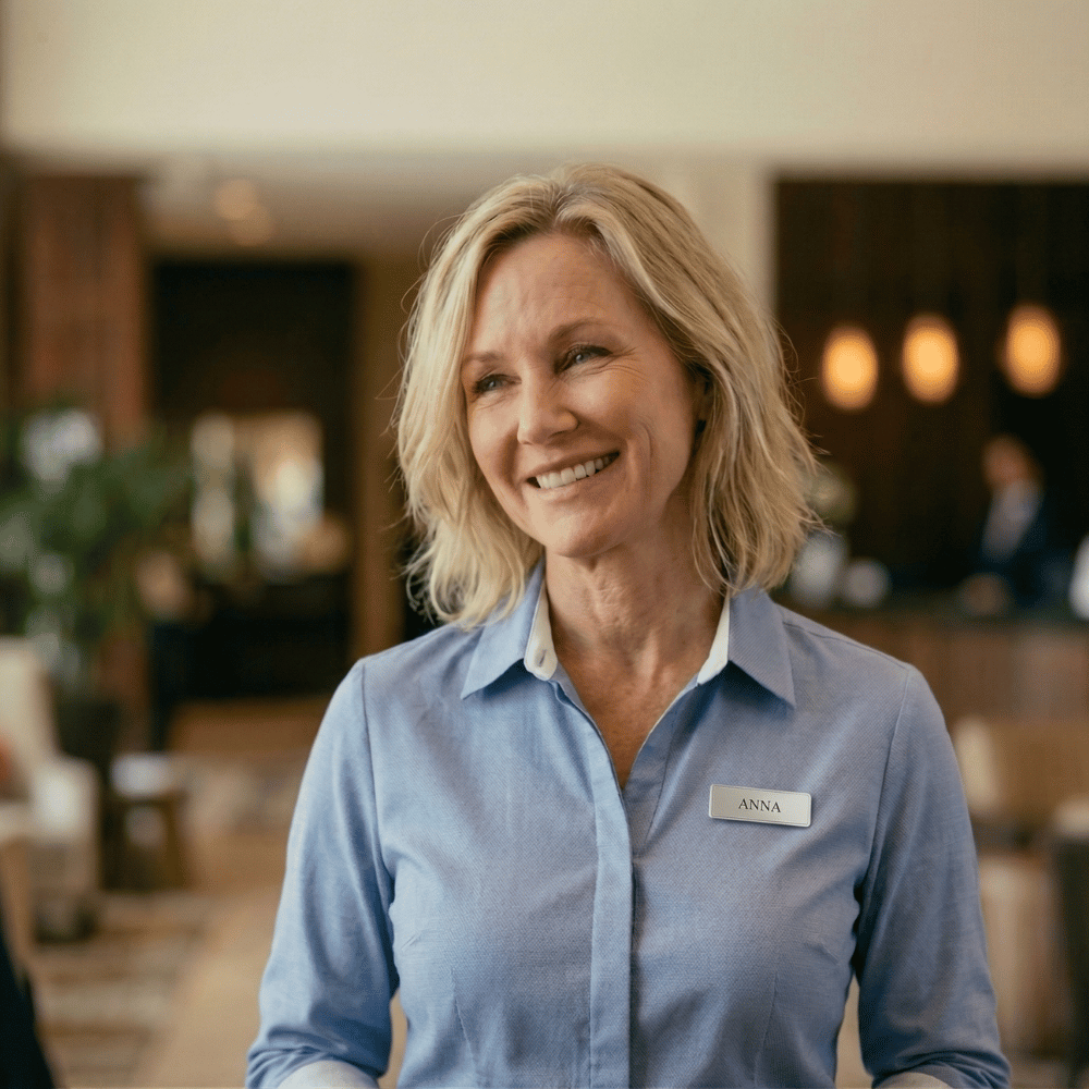 Club team member Anna welcoming guests in a venue foyer